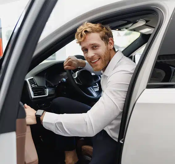 Business owner sitting in his company car is happy that he calculated his CHP finance repayments on his new work car with Jade Finance.
