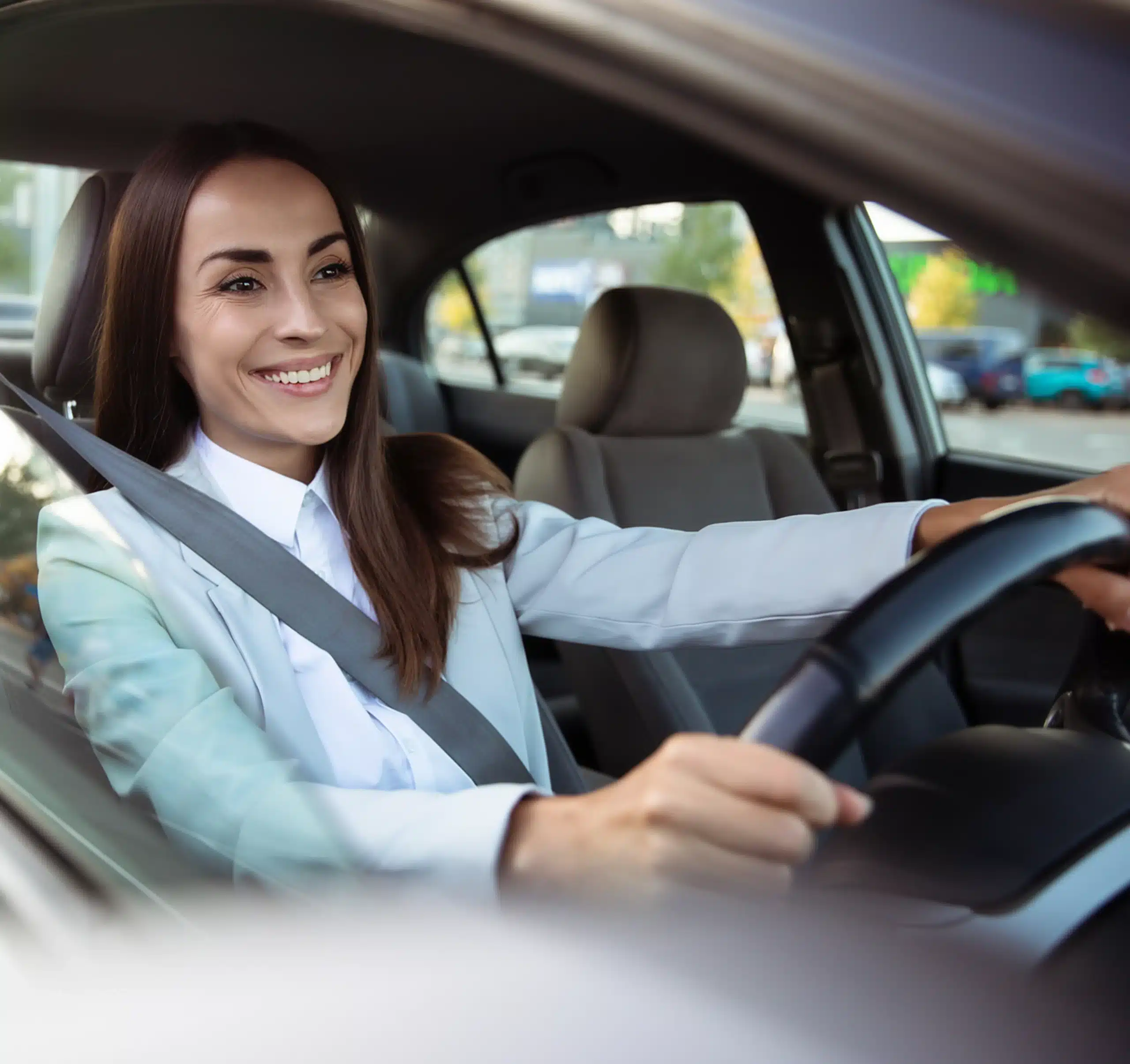 Woman driving a new modern car in good mood