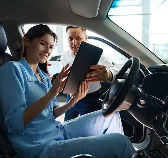 Jade Finance consultant providing personal low rate options to customer on a tablet after using the car finance calculator with balloon.