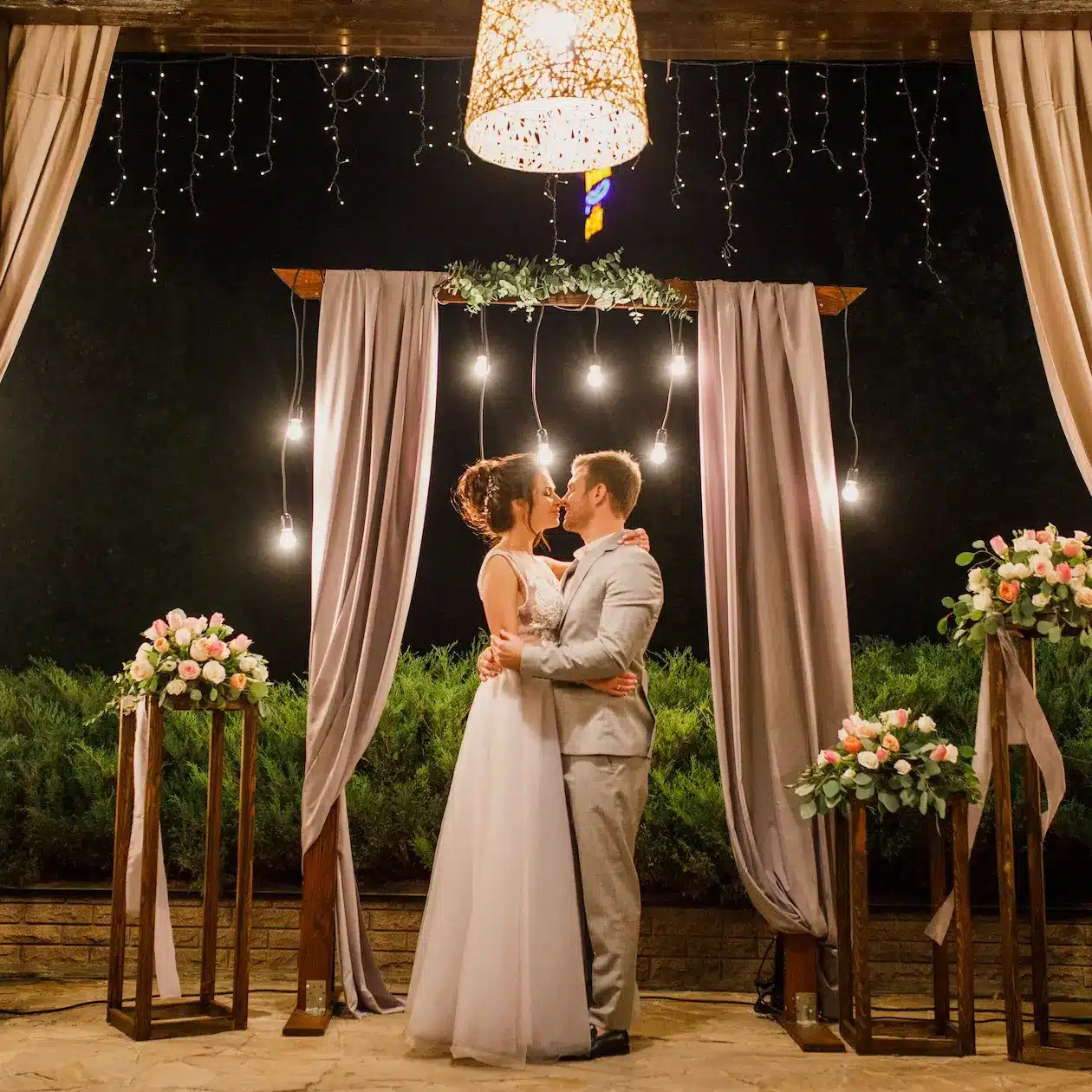 A newly married couple slow dancing during their reception on the night of their wedding day