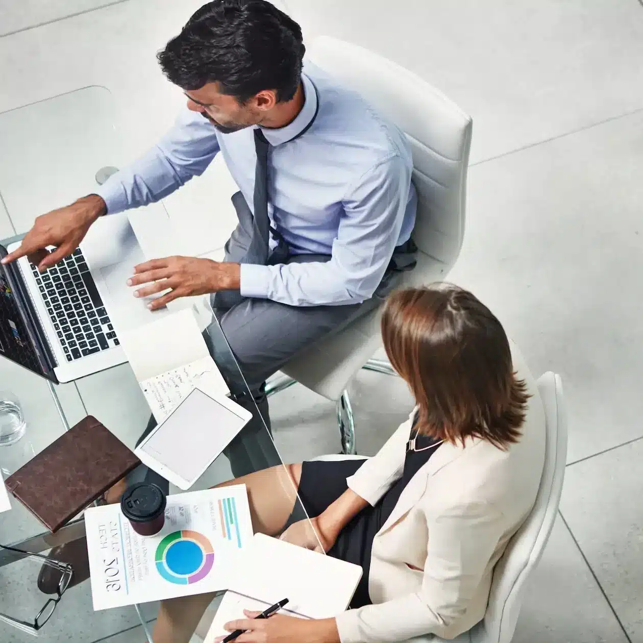 Two business people having a meeting about their options for business chattel mortgages, arial view from higher floor