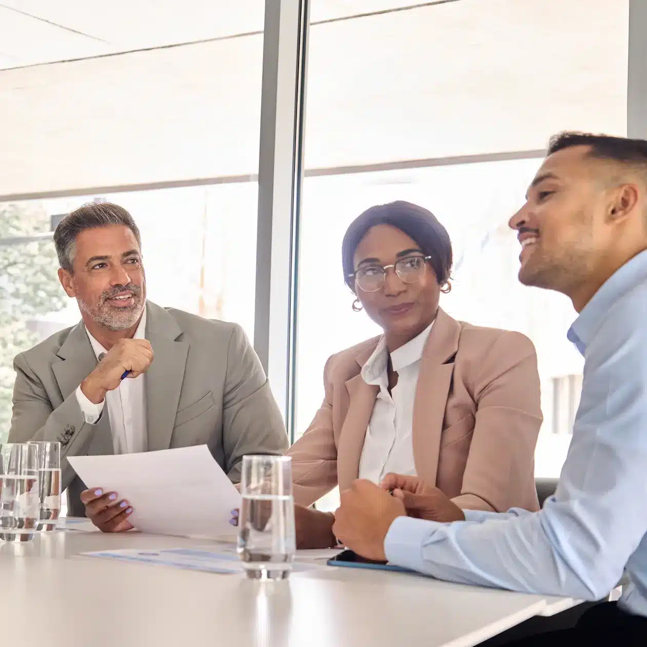 Business owners sitting around a table discussing commercial loan repayments offered by Jade Finance's specialist broker.