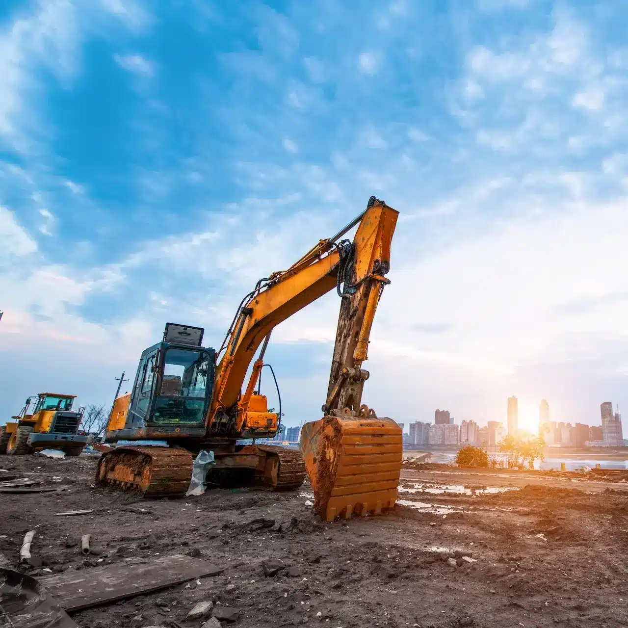 Earthmoving equipment working on a construction site during a sunny day