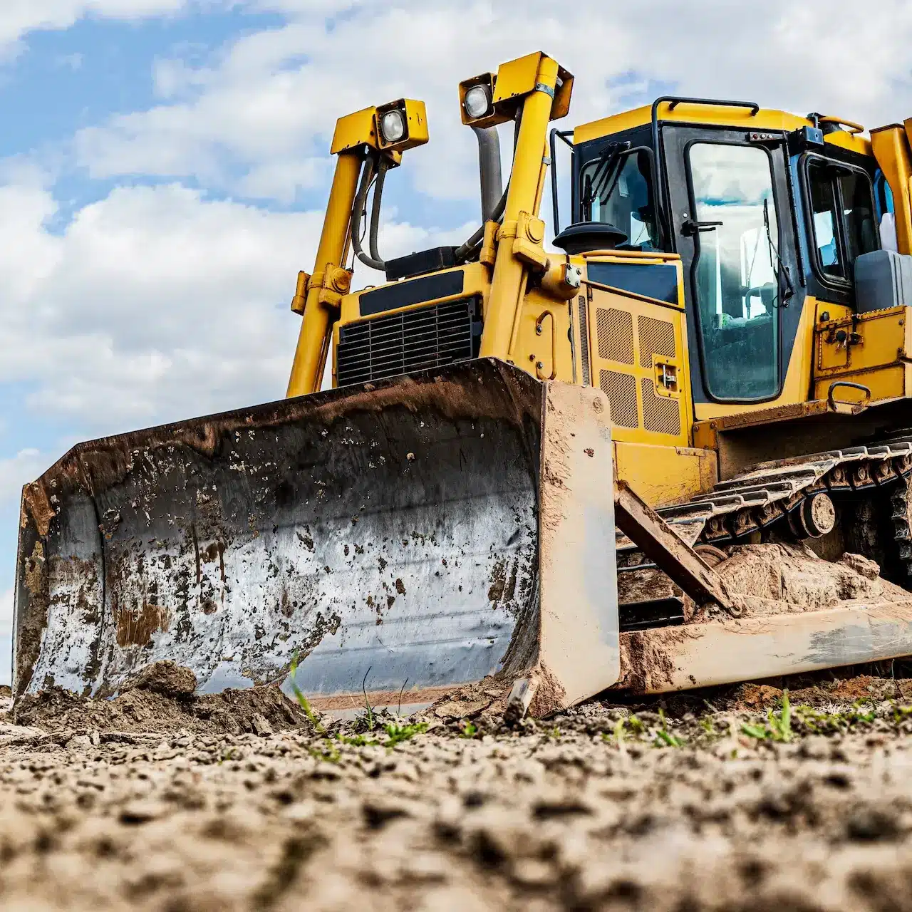 A large skid steer dozer parked on a construction site