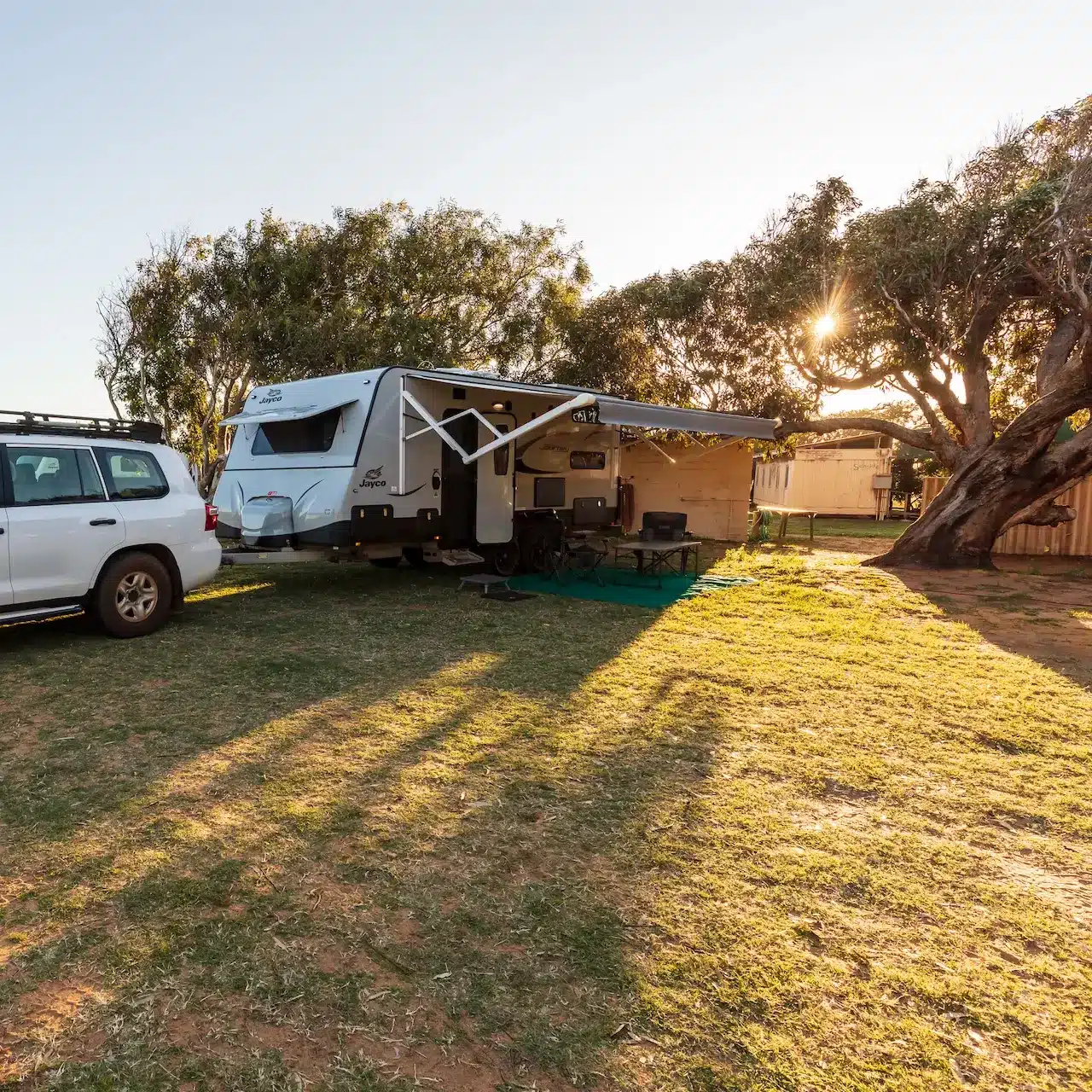 4WD and caravan parked in a camp ground early morning