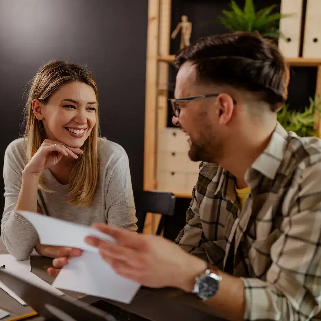 A couple sitting at their dining table discussing their finances