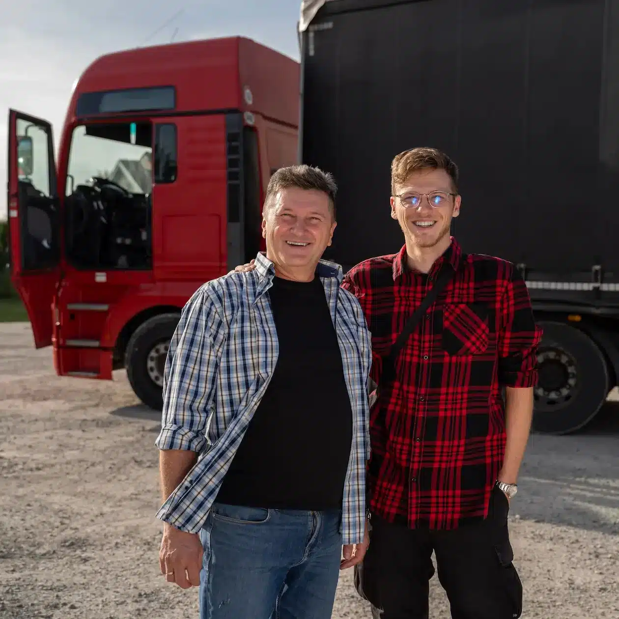 Father and son standing in front of their new truck they are purchasing with a rent to own finance package