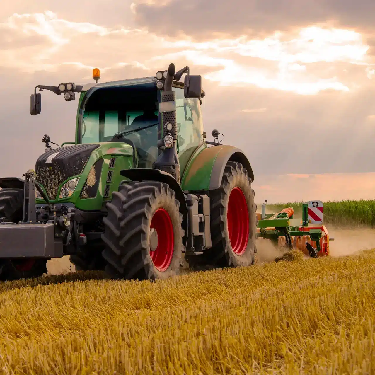 A large tractor tilling a crop