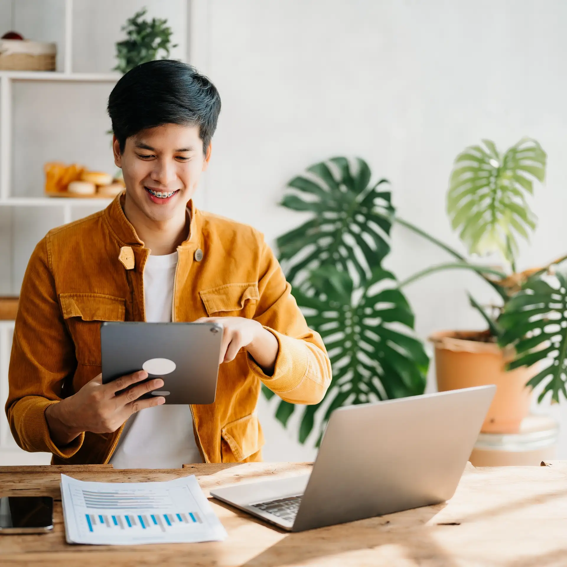 Young Asian business man working at home office with laptop