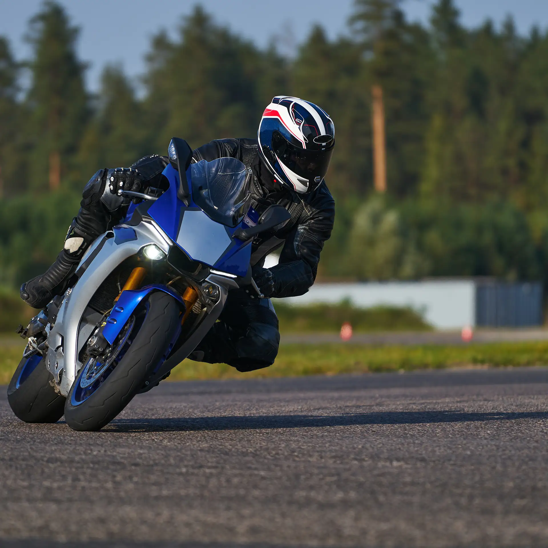 Motorcyclist in black riding his super sport motorcycle