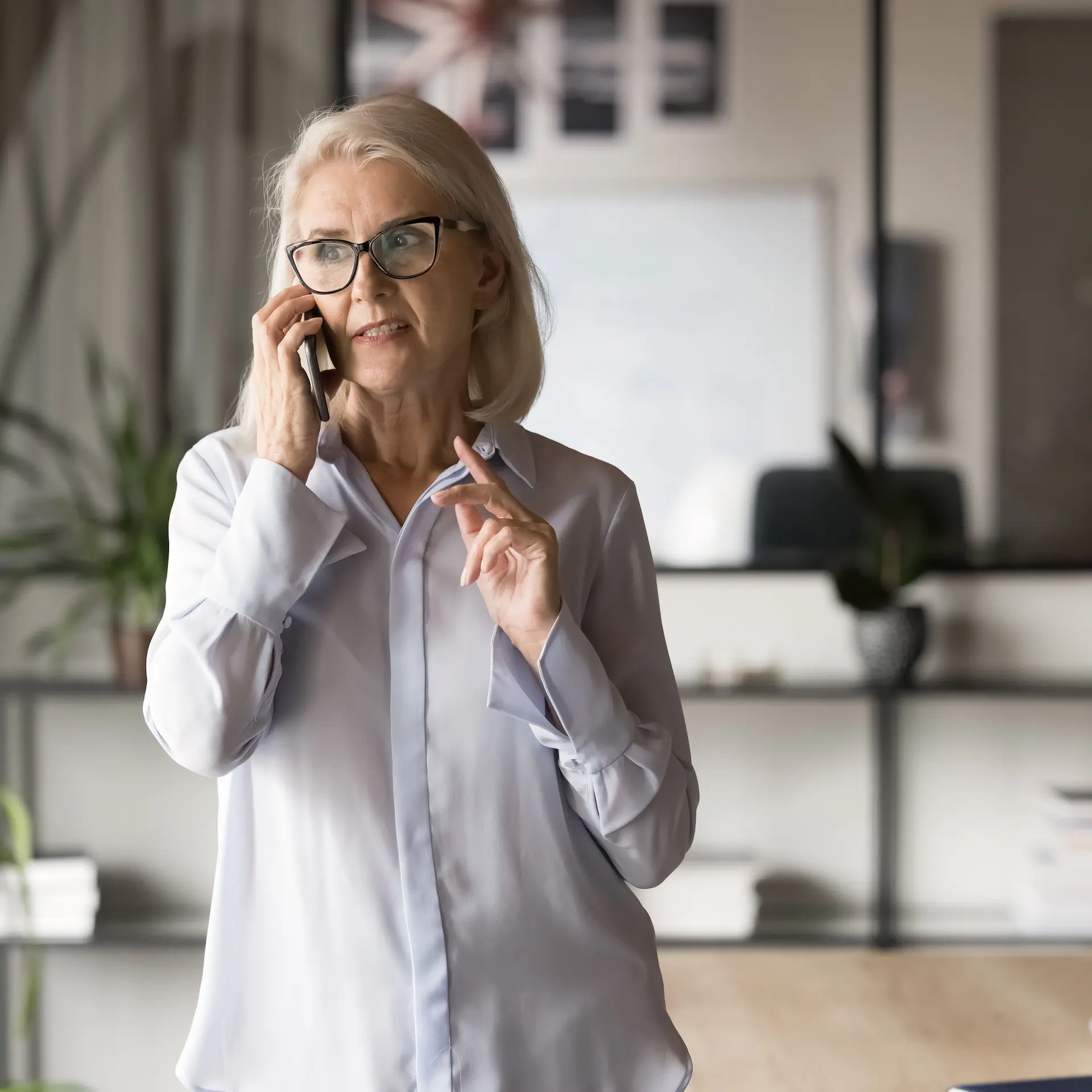 A lady having a confidential phone conversation with a trusted broker at Jade Finance.