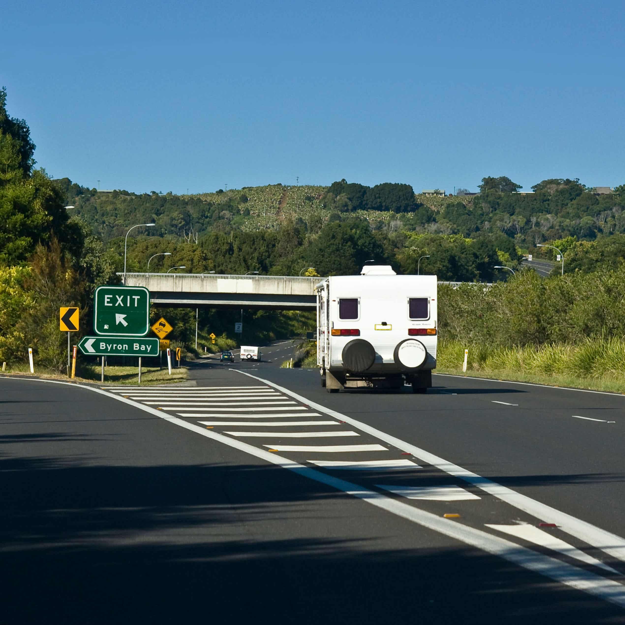 A caravan travelling down the open highway past the Byron Bay exit.