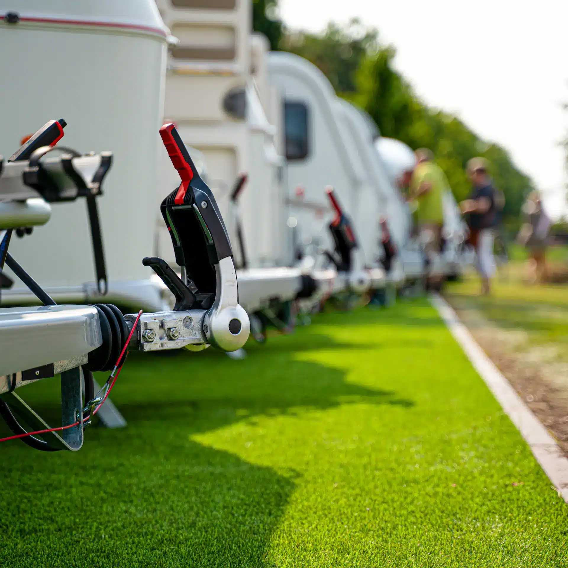 A row of new caravans lined up at a caravan dealership.