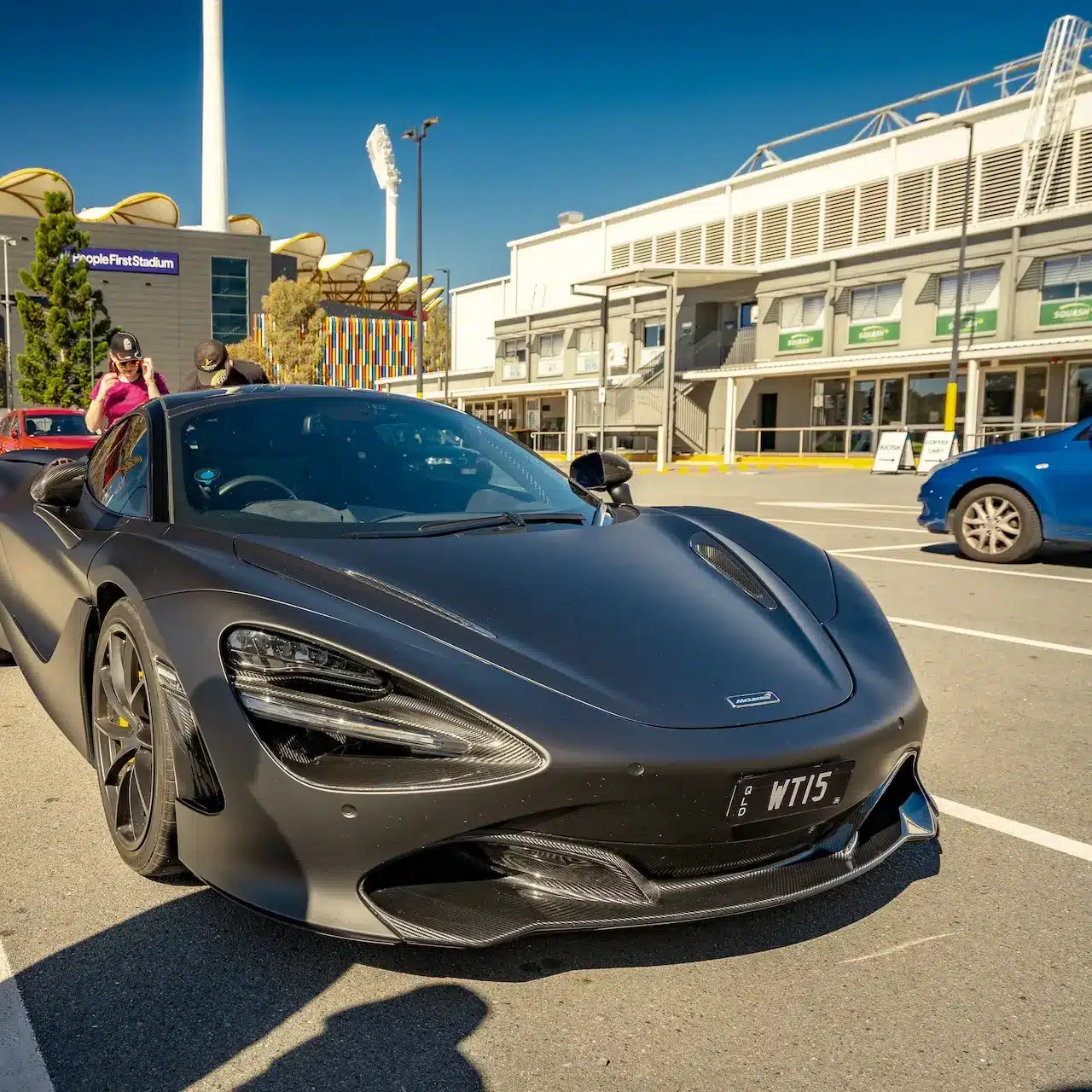 Grey McLaren 720S parked in a stadium carpark on the Gold Coast on a sunny day