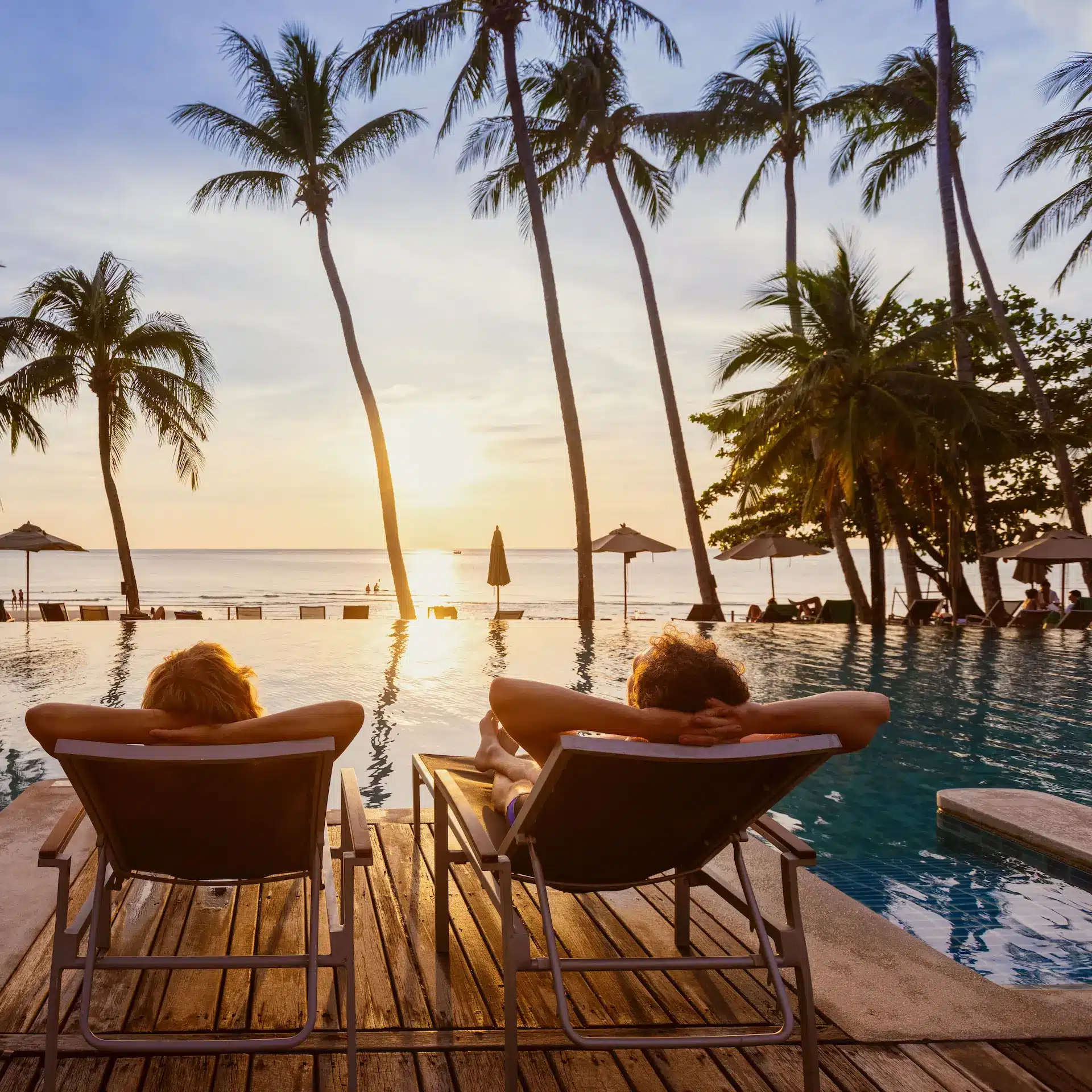 A couple relaxing by the pool on their holiday made possible with a personal loan from Jade Finance