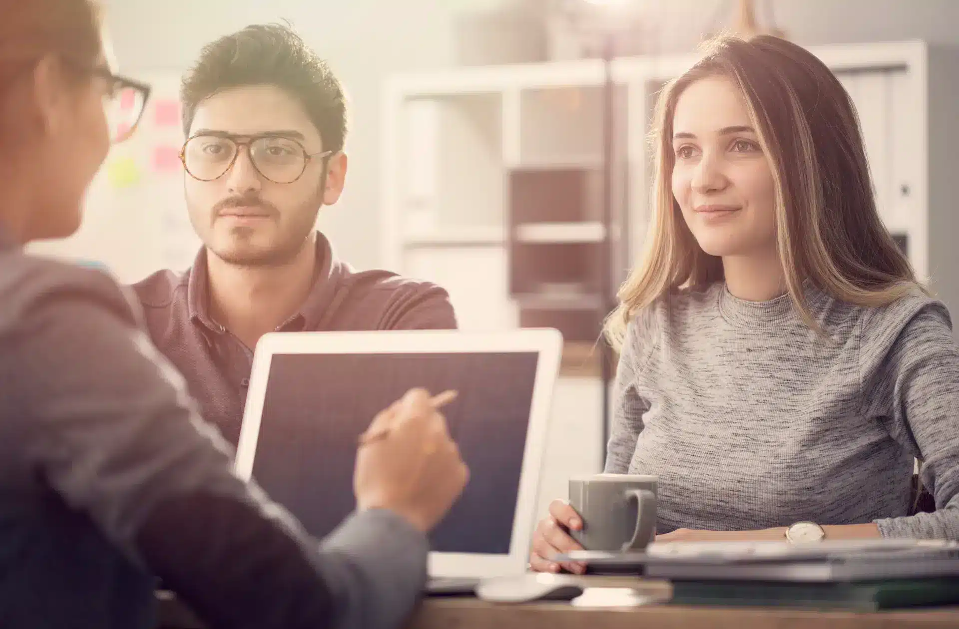 A Couple getting personalised finance options from a jade finance specialist after applying for a loan through the car loan balloon calculator form.